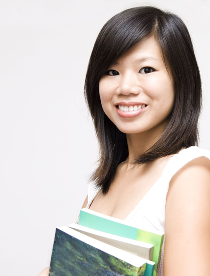 Asian female student holding book