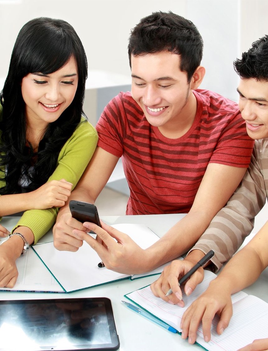 Asian students at table w calculator